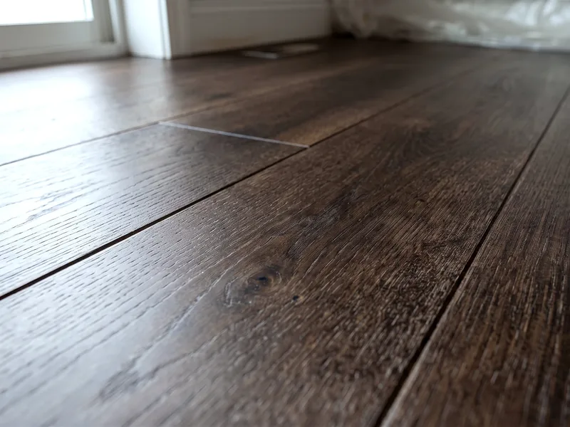 The same wood floor after post-construction cleaning, clear of dust and debris